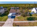 Aerial view of a single-Gathering home with a large backyard and waterfront access at 4610 Bay Crest Dr, Tampa, FL 33615