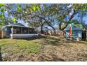 Large backyard with a screened porch and shed, providing ample outdoor space at 605 E Spruce St, Tarpon Springs, FL 34689