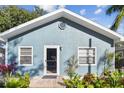 House exterior showcasing a light blue facade and welcoming front entrance at 605 E Spruce St, Tarpon Springs, FL 34689