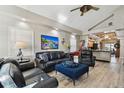 Spacious living room featuring leather furniture, hardwood floors, and an open floor plan at 605 E Spruce St, Tarpon Springs, FL 34689