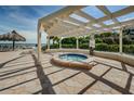 Relaxing hot tub area with pergola and ocean views at 6382 Palma Del Mar S Blvd # 123, St Petersburg, FL 33715