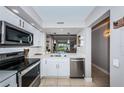 Modern kitchen with stainless steel appliances and white cabinets at 6382 Palma Del Mar S Blvd # 123, St Petersburg, FL 33715