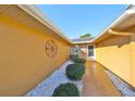 Front entry with decorative tile and landscaped walkway at 703 Elkhorn Rd, Sun City Center, FL 33573