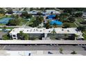 Aerial view of condominium complex showcasing building and landscaping at 970 Virginia St # 109, Dunedin, FL 34698