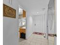 Condo entryway with tile floors and kitchen peek at 1814 Mariner Dr # 159, Tarpon Springs, FL 34689