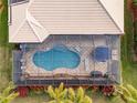 Aerial view of a kidney-shaped pool with a screened enclosure at 5006 Ruby Flats Dr, Wimauma, FL 33598