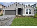 Curb appeal abounds in this charming one-story home, featuring a two-car garage and attractive landscaping at 36159 Welsh Glade Rd, Dade City, FL 33525