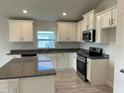 Modern kitchen with stainless steel appliances and granite countertops at 36159 Welsh Glade Rd, Dade City, FL 33525