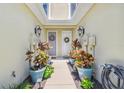 Shared entry between two units, with lush potted plants at 521 Harbor Ridge Dr, Palm Harbor, FL 34683