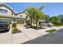 Townhome with palm trees, two-car garage and driveway at 521 Harbor Ridge Dr, Palm Harbor, FL 34683