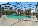 Relaxing kidney-shaped pool with a screened enclosure at 601 42Nd Ne Ave, St Petersburg, FL 33703