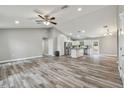Open concept living room and kitchen with luxury vinyl plank flooring at 6103 Fairway Dr, Ridge Manor, FL 33523