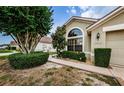 Well-maintained house exterior with manicured landscaping and walkway at 9305 Haas Dr, Hudson, FL 34669