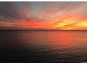 Orange and red sunset over calm ocean at 100 Bluff View Dr # 415A, Belleair Bluffs, FL 33770