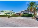 Two houses side-by-side with green exteriors and landscaping at 16101 6Th E St, Redington Beach, FL 33708