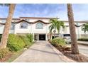 Attractive townhouse with a driveway, lush greenery, and a one car garage adding to its curb appeal at 273 Madeira Cir, Tierra Verde, FL 33715