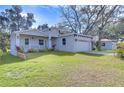 Newly built home features a gray exterior, lush lawn, and a two-car garage at 3125 Downing St, Clearwater, FL 33759