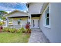 Front porch with gray exterior, white columns, and walkway at 3125 Downing St, Clearwater, FL 33759
