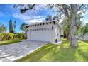 Two-car garage with a gray exterior and paved driveway at 3125 Downing St, Clearwater, FL 33759