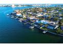 Aerial view showcasing a waterfront home and community at 380 Belle Point Dr, St Pete Beach, FL 33706