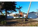 Single story home with carport and mature landscaping at 380 Belle Point Dr, St Pete Beach, FL 33706