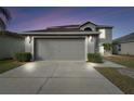 Two-story house with attached garage, landscaping, and driveway at 6213 Venezia Pl, Riverview, FL 33578