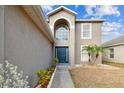 Two-story house with a dark blue door and landscaping at 6213 Venezia Pl, Riverview, FL 33578