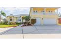 Two-story house with a large driveway, two-car garage, and balcony at 924 Bunker View Dr, Apollo Beach, FL 33572
