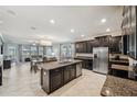 Spacious kitchen with dark cabinetry, granite counters, and stainless steel appliances at 9928 Ivory Dr, Ruskin, FL 33573