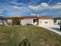 Ranch style home with a large yard and attached garage at 11365 8Th E St, Treasure Island, FL 33706