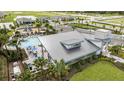 Community pool and clubhouse with surrounding homes at 12404 52Th E St, Parrish, FL 34219