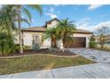 Front view of a house with a landscaped yard at 18052 Java Isle Dr, Tampa, FL 33647