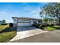 Bright and airy home exterior with a two-car garage and landscaped front yard at 2407 Locksley St # 224, Sun City Center, FL 33573