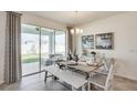 Dining room with a farmhouse table, bench seating, and access to backyard at 3542 Thistle Bank Ct, Plant City, FL 33565