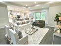 Bright and open-concept living room featuring hardwood floors and seamless transition to the kitchen at 5062 Elm Leaf Dr, Brooksville, FL 34601