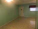 Spacious living room with light teal walls and tile floors at 12760 Indian Rocks Rd # 562, Largo, FL 33774
