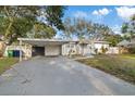 Charming single-story home with carport and well-maintained lawn at 1504 E Mcberry St, Tampa, FL 33610