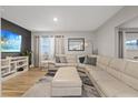 Bright living room features a large sectional sofa, modern decor, and wood-look floors at 1504 E Mcberry St, Tampa, FL 33610