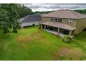 Large backyard with a patio and plenty of green space at 26888 Fiddlewood Loop, Wesley Chapel, FL 33544