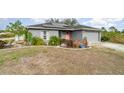 Gray house with solar panels and a landscaped yard at 5956 Nyberg Rd, North Port, FL 34291