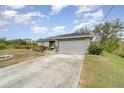 Gray house with solar panels and a long driveway at 5956 Nyberg Rd, North Port, FL 34291