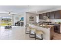Modern kitchen with dark cabinets, granite countertops, and an island at 7041 Broad River Ave, Land O Lakes, FL 34638
