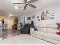 Spacious living room with comfortable seating, a decorative tree, and an open floor plan at 9024 White Sage Loop # 37, Lakewood Ranch, FL 34202
