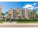 Sand Castle III building exterior, featuring a modern design and lush landscaping at 20040 Gulf Blvd # 605, Indian Shores, FL 33785