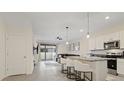 Modern kitchen with white cabinets, granite countertops, and stainless steel appliances at 2920 Evergreen Elm Pass, Wesley Chapel, FL 33543