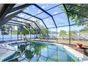 Screened-in pool with mature landscaping for privacy and relaxation at 3613 S Omar Ave, Tampa, FL 33629