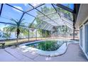 Enclosed pool with lush landscaping and seating area at 3613 S Omar Ave, Tampa, FL 33629