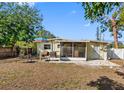 Backyard featuring a screened-in porch, patio, and grill perfect for outdoor entertaining at 538 Southwest N Blvd, St Petersburg, FL 33703