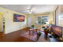 Bright living room with hardwood floors, a ceiling fan, and large windows at 538 Southwest N Blvd, St Petersburg, FL 33703