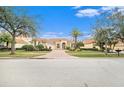 House exterior with a three-car garage and manicured lawn at 8478 Dunham Station Dr, Tampa, FL 33647